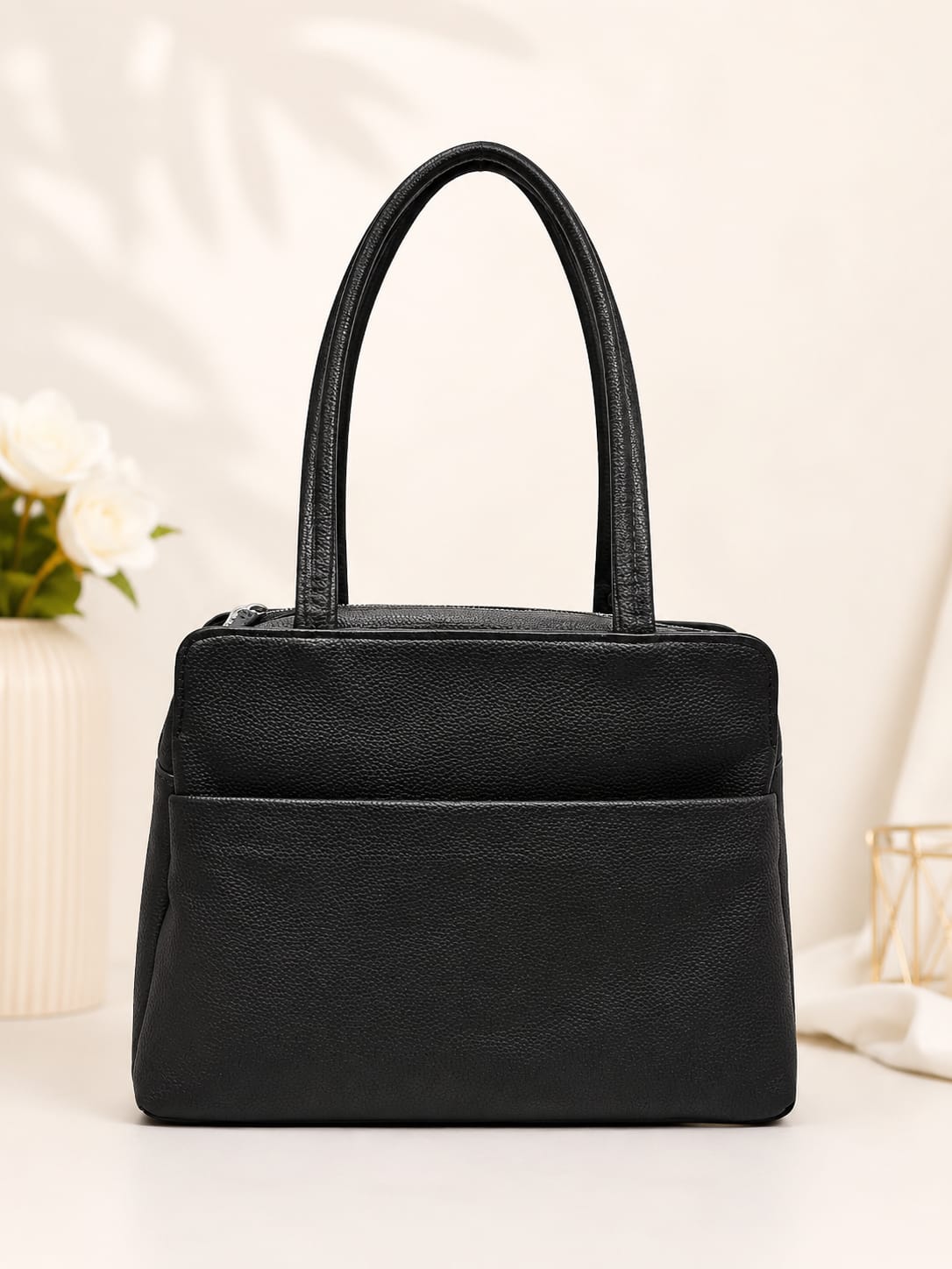Black pebbled leather shoulder bag – front view with buckle detail