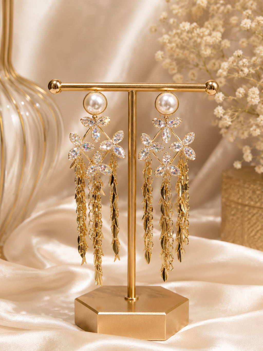 Pearl and crystal flower gold tassel drop earrings on display stand