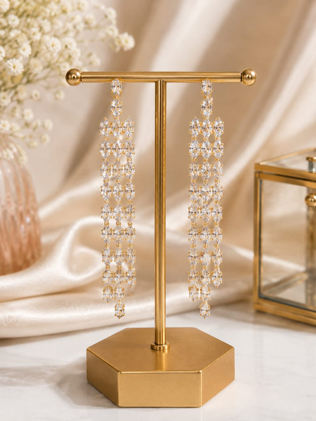 Crystal lattice long drop earrings on gold display stand