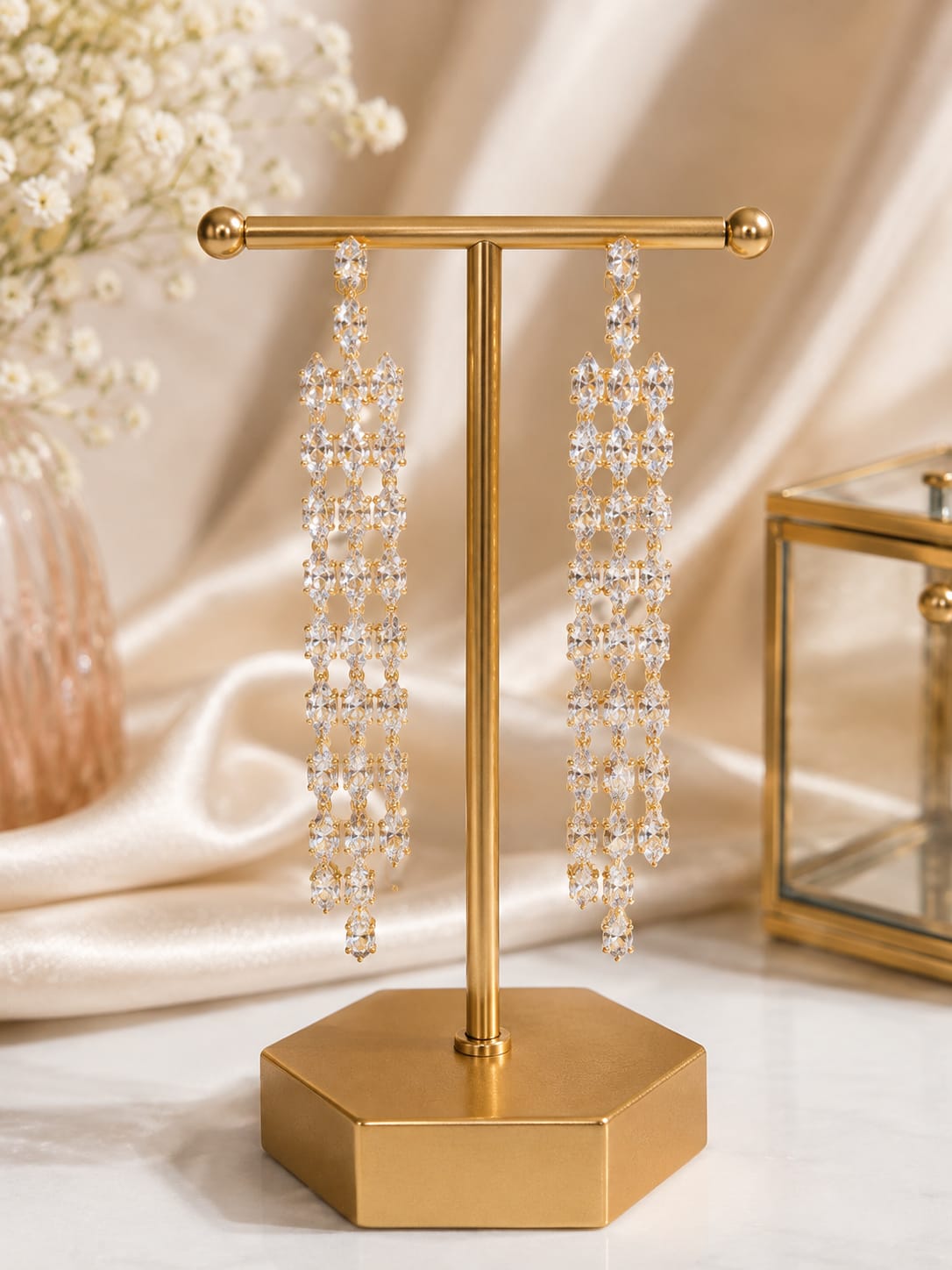 Crystal lattice long drop earrings on gold display stand