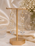 Butterfly crystal baguette tassel drop earrings on gold display stand
